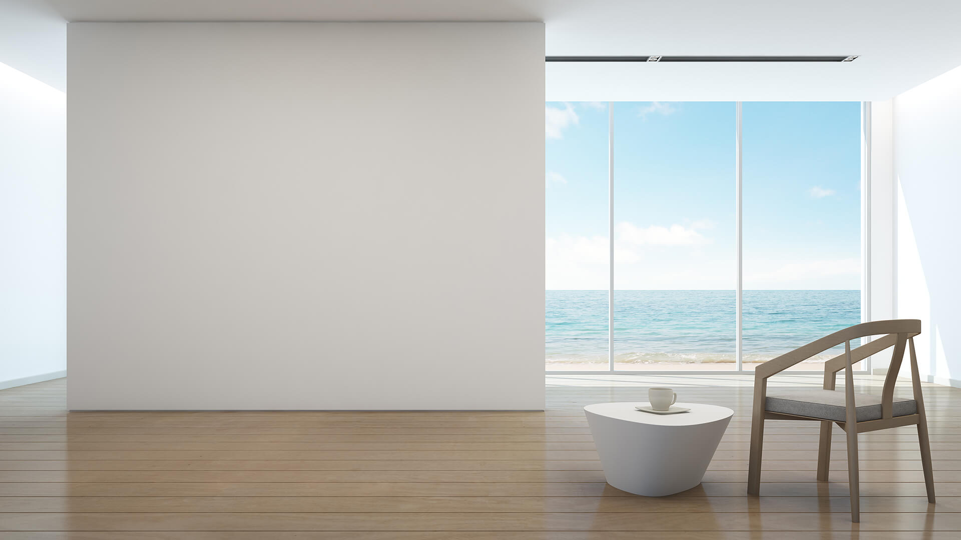 Modern minimalist interior with painted wall, wooden floor, chair, small table, and sea view through large window